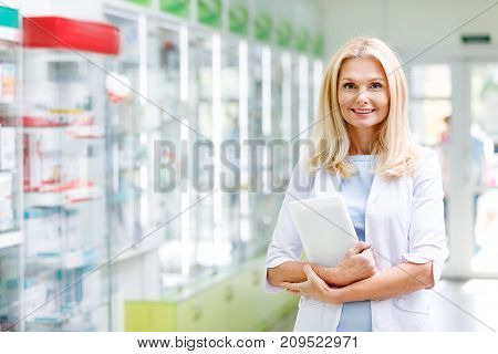 Pharmacist With Digital Tablet In Drugstore