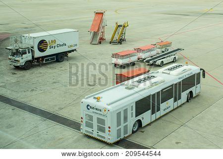 BANGKOK THAILAND  21 JULY 2017: Ground support equipment and bus waiting for a plane to the gate at the gate in Don Mueang international airport (DMK)