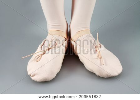 Close up of a ballet slippers. Legs in ballet slippers.