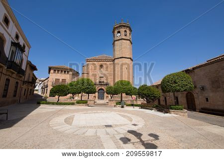 landmark Constitution Square with facade and bell tower of church San Mateo gothic and renaissance from Fifteenth century in old town of Banos de la Encina Jaen Andalusia Spain Europe