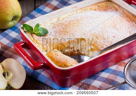 Apple pudding on a cutting board on a table