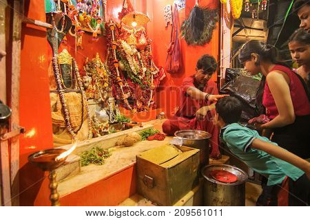 KOLKATA WEST BENGAL INDIA - 13 MAY 2017: Hindu priest worshipping Lord Hanuman known as Hanuman ji in India. Hindu religious persons are praying in front of the idol in the holy temple.