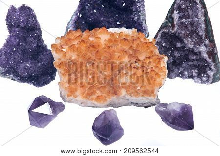 Citrine druzy cluster surrounded by amethyst druzy clusters and points  isolated on white background