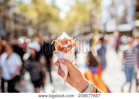 Holding jamon traditional spanish jerked meat outdoors on the street in Barcelona