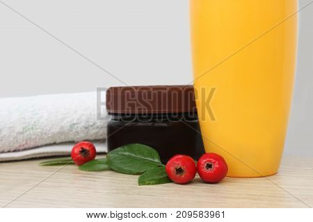 Two jars of cream berries and a towel. daily care