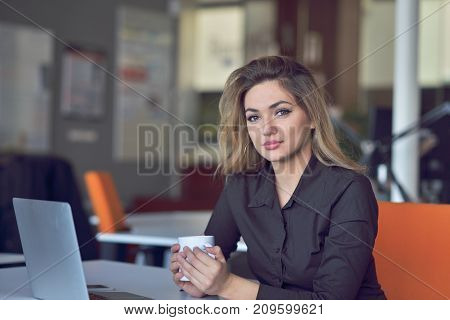 Young and beautiful businesswoman tired from work in the office.Woman holding her head