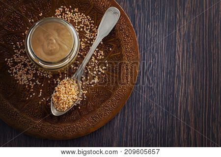 jar of homemade tahini with sesame seeds - food and drink