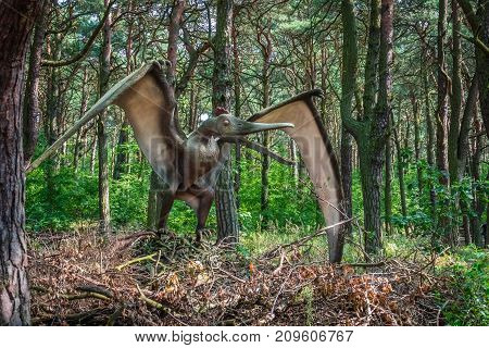 Life sized Pterodactyl dinosaur statue in a forest