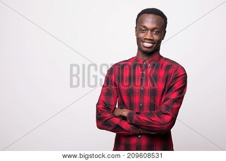Smiling African Guy With Crossed Arms Against White Background