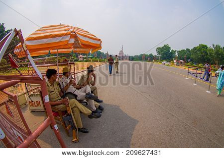 Jaipur, India - September 26, 2017: Police officers under an umbrella at the enter of the Goverment building of Rashtrapati Bhavan is the official home of the President of India.
