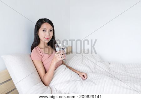Woman holding glass of water