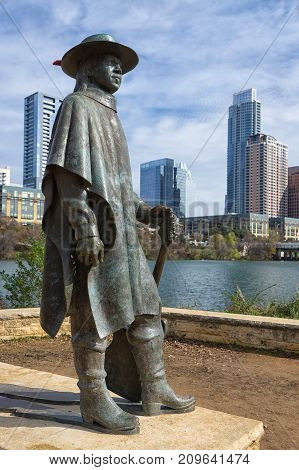 December 31, 2015 Austin Texas USA: bronze sculpture of Stevie Ray Vaughan by Ralph Helmic with the downtown in the background