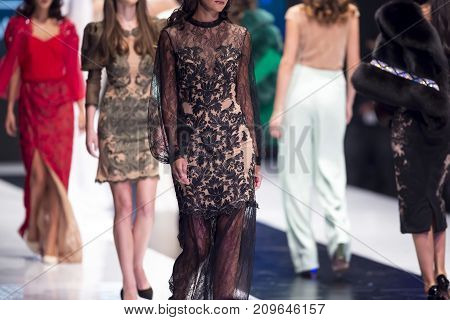 Sofia, Bulgaria - 28 September, 2017: Female models walk the runway in different dresses during a Fashion Show. Fashion catwalk event showing new collection of clothes. In a row.