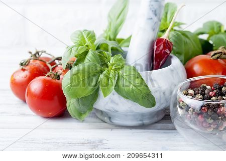 Tomatoes And Bunch Of Fresh Green Basil On A White Wood Background,