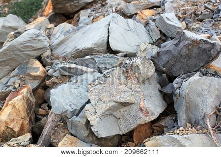 Cracks and colorful layers of sandstone background. A big heap of sandstones storage space of various natural sandstone. The pattern of the variegated sandstones. Layers of toning colored large stones