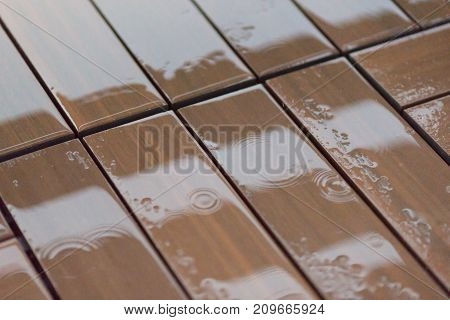 Wet wooden floor boards with water drops