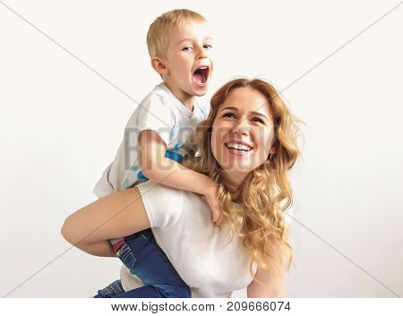 Portrait Of A Happy Mother And Her Young Son. Mother And Little Boy Play,