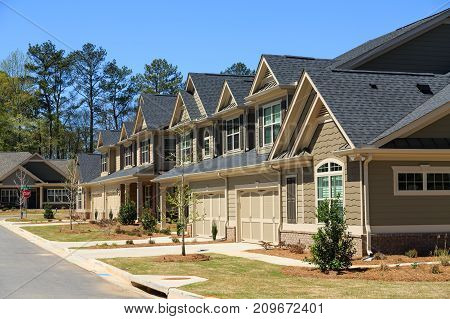 A row of modern townhouses in a new subdivision