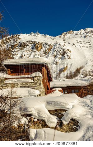 Alpine winter mountain landscape. French Alps covered with snow in sunny day. Val-d'Isere, France