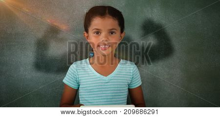 Silhouette of man flexing muscels against young girl holding digital tablet