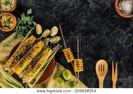 Grilled Corncobs With Wooden Spatulas