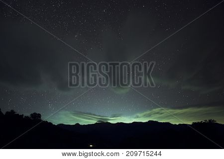 Long exposure and High ISO shot of star and cloud over the mountain at night.