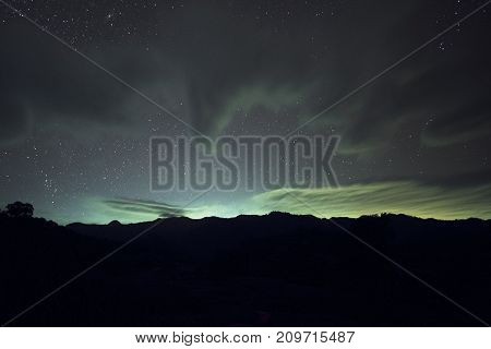 Long exposure and High ISO shot of star and cloud over the mountain at night.