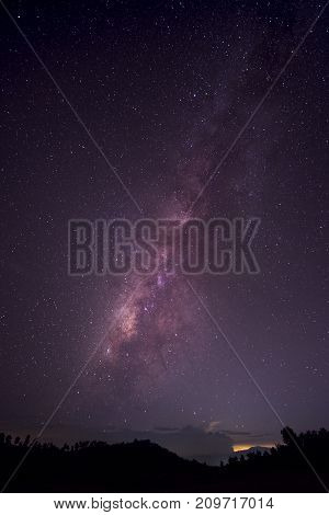 Long exposure and High ISO shot of star and milky way over the mountain at night. Red tone tone effect.
