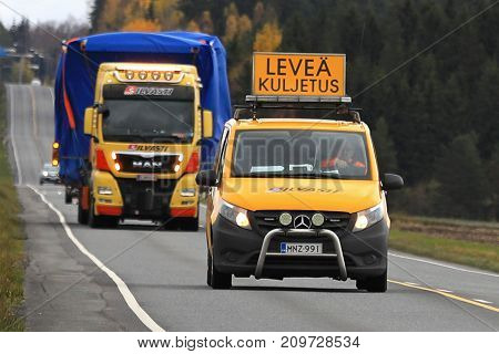 JOKIOINEN FINLAND - OCTOBER 13 2017: MAN TGX wide load truck transport by Silvasti Heavy is led by pilot vehicle along highway in South of Finland.