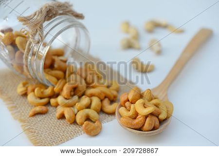 Roasted cashews. Organic roasted cashews In a wooden spoon