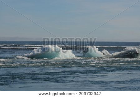 Beautiful icebergs floating in the vast waters of Iceland