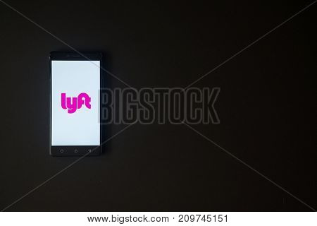 Los Angeles, USA, october 19, 2017: Lyft logo on smartphone screen on black background.