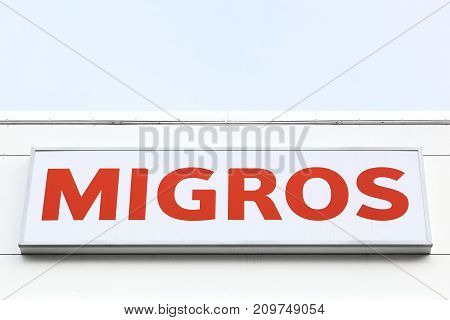 Geneva, Switzerland - October 1, 2017: Migros logo on a wall. Migros is Switzerland's largest retail company, its largest supermarket chain and largest employer