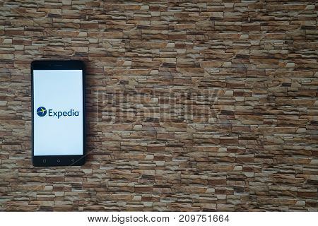 Los Angeles, USA, october 19, 2017: Expedia logo on smartphone screen on stone facing background