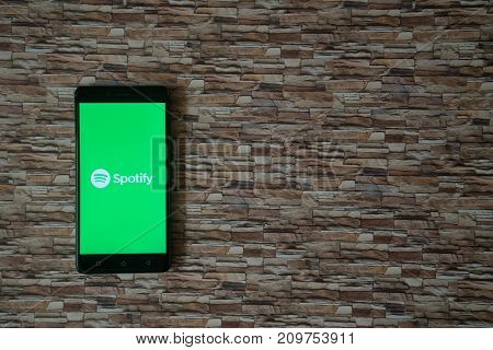 Los Angeles, USA, october 19, 2017: Spotify logo on smartphone screen on stone facing background