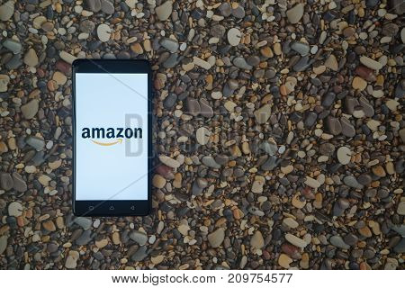 Los Angeles, USA, october 18, 2017: Amazon logo on smartphone on background of small stones