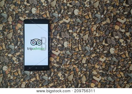 Los Angeles, USA, october 18, 2017: Tripadvisor logo on smartphone on background of small stones