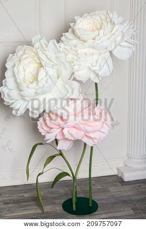 Decoration artificial Peonies on the stand on white hall background.