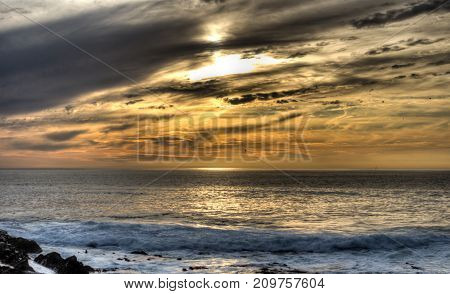Silver and gold seascape sunset taken at Greenpoint in Cape Town, South Africa