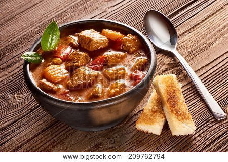 Goulash, Beef Stew With Herbs On Wooden Background