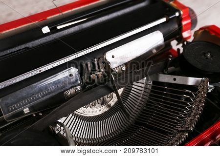 Red vintage typewriter maschine on the table. Close up image
