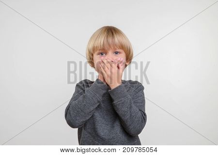 Horisontal emotional cute portrait of caucasian boy. Handsome happy child, white background