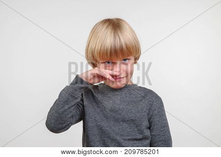 Portrait of handsome happy child, picture on gray background