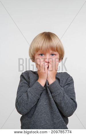 New cute vertical emotional portrait of caucasian boy