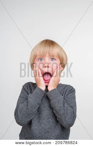 Emotional portrait of caucasian boy isolated on white background