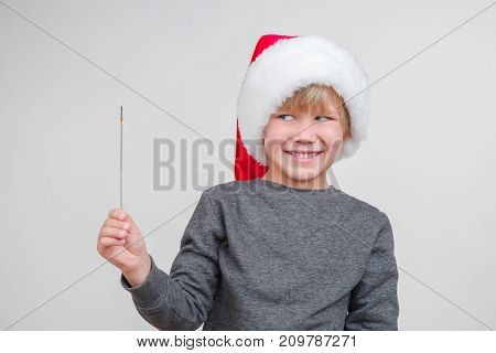 New horisontal emotional portrait of caucasian boy with santa claus red hat