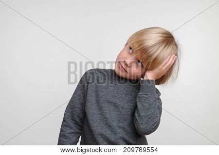 Horisontal portrait of caucasian boy. Handsome happy child, photo on grey background