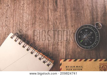 Vintage compass on the very old paper or letter envolop on table