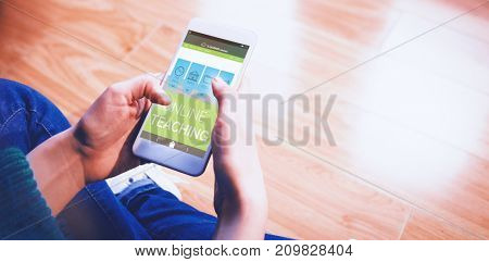 Digital 3D image of online education interface on screen against cropped image of woman sitting on floor while using her phone