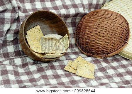 Whole grain crackers / crispy bread in wooden bowl on the table in the kitchen